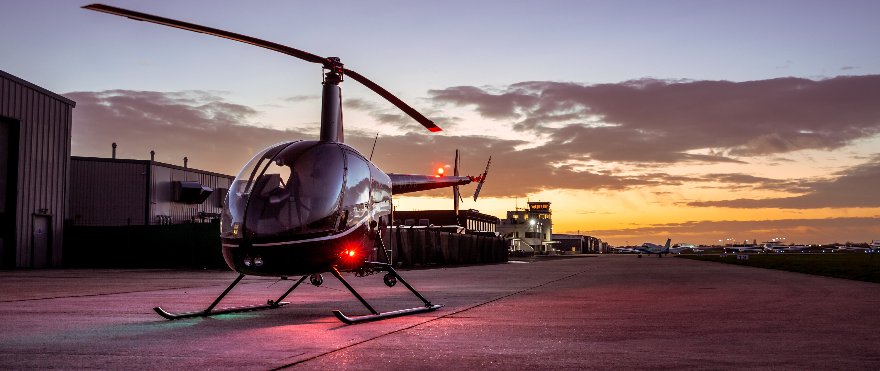 Robinson R22 helicopter in sunset